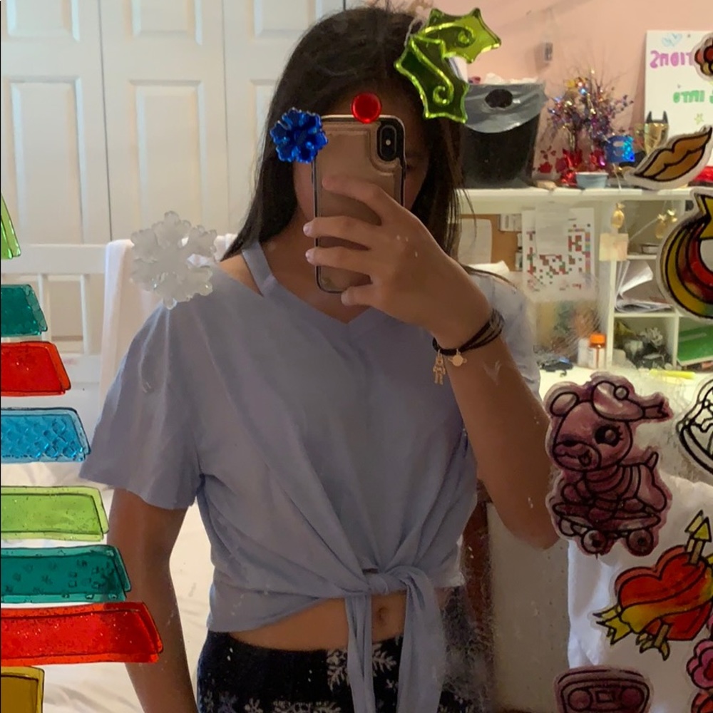 light blue shirt with shoulder cut outs; cropped